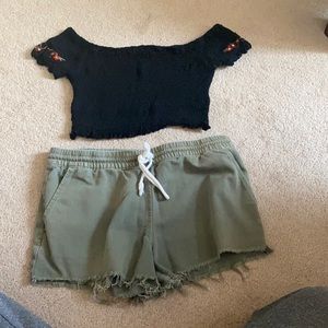 Outfit: black top with floral design, green shorts